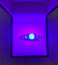 strong blue fluorescence in five stone diamond ring